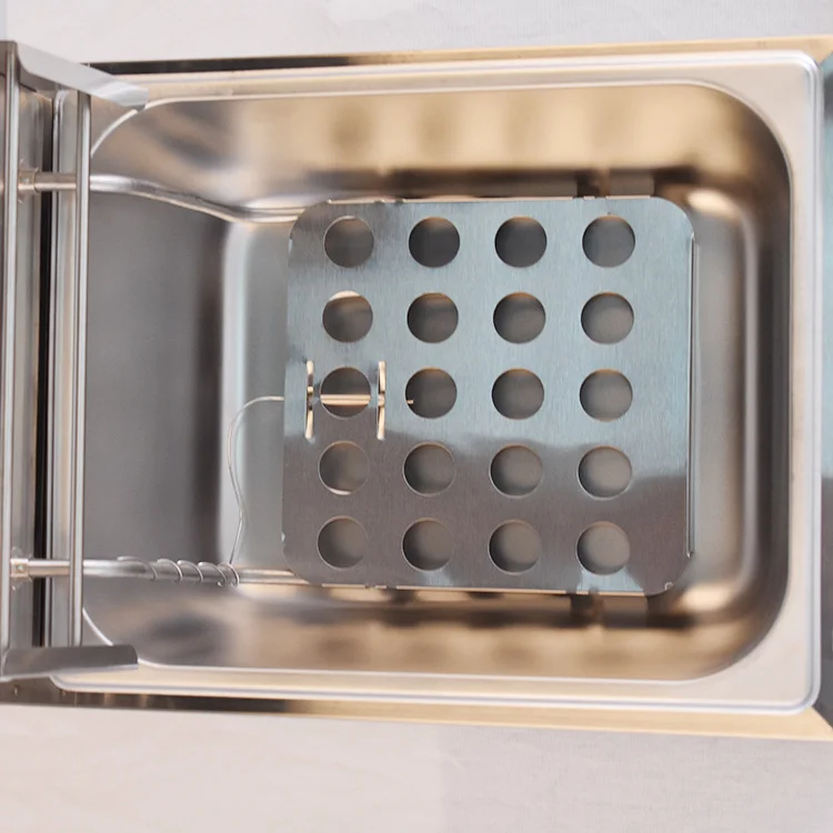 Commercial electric deep fryer with the lid open and frying basket in place